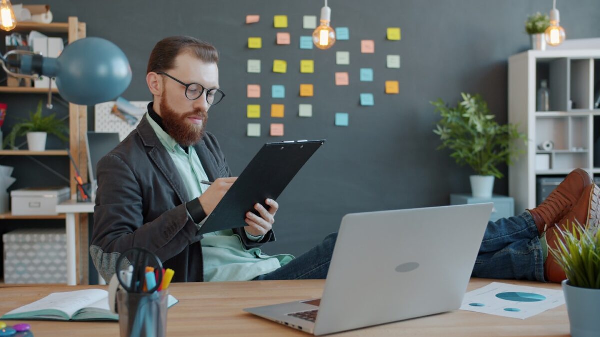 Creator reviewing licensing terms on a laptop for AI art sales